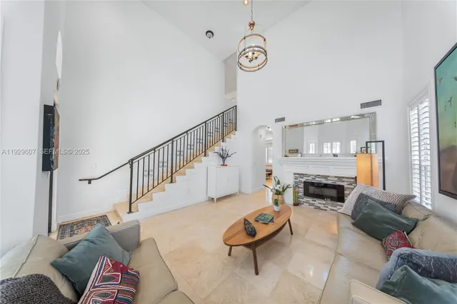 a living room with furniture fireplace and a window