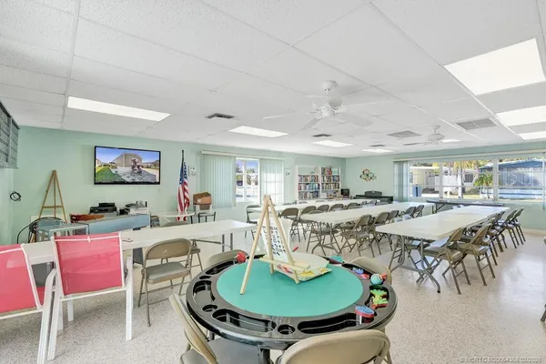 a living room with furniture a table and wooden floor