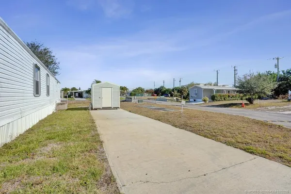 a view of an house with backyard and road