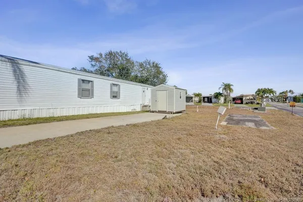 a backyard of a house with table and chairs