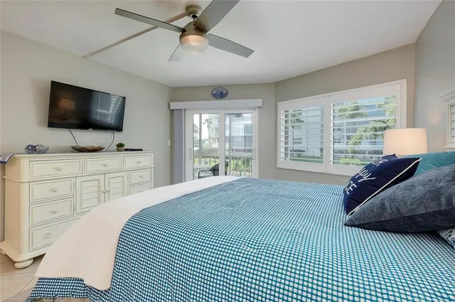 a bedroom with a large bed and a flat screen tv