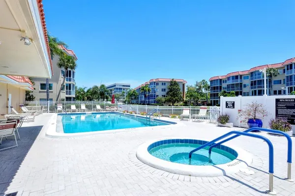 a view of a swimming pool with a patio and a yard