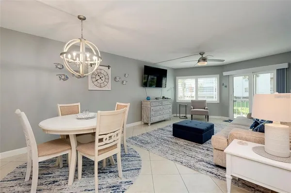 a view of a dining room with furniture a livingroom and chandelier