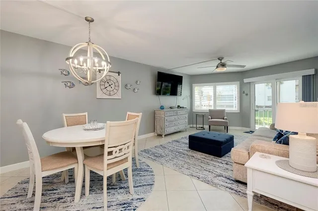 a view of a dining room with furniture a livingroom and chandelier