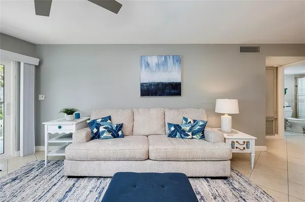 a living room with furniture and a lamp