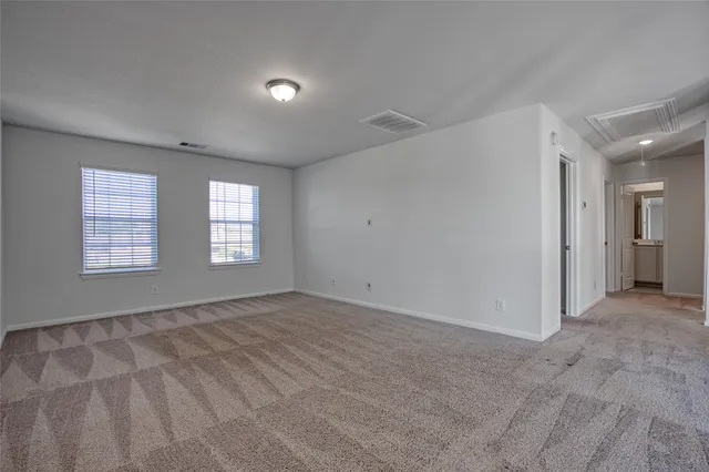 a bathroom with a sink a toilet and a large mirror