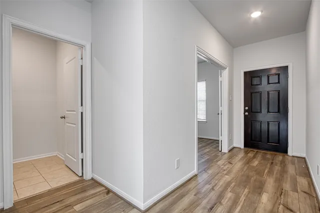a view of hallway with wooden floor