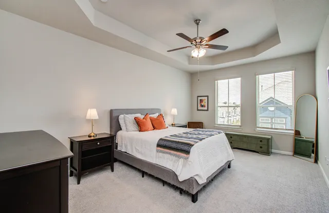 a bed room with a bed and a chandelier