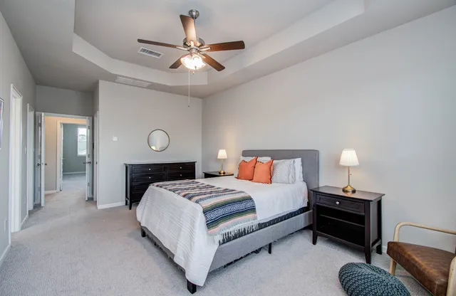 a bedroom with a bed couch and a window