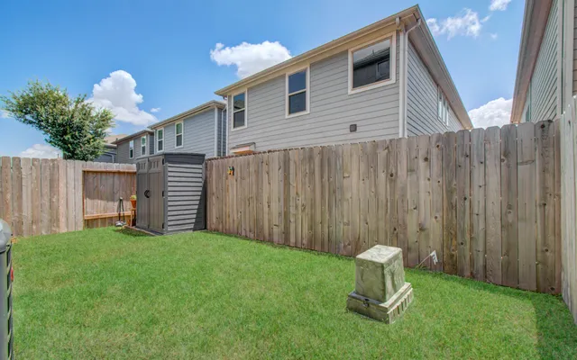 a backyard of a house with table and chairs