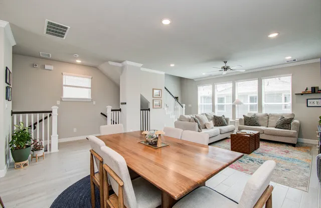 a living room with furniture wooden floor and a large window