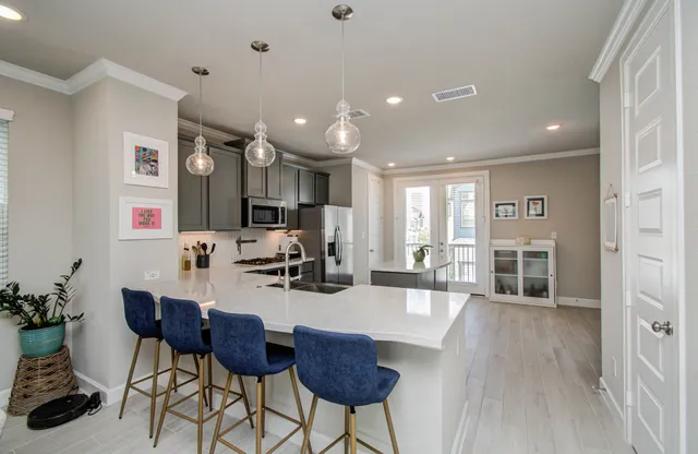 a view of a dining room with furniture a chandelier and wooden floor