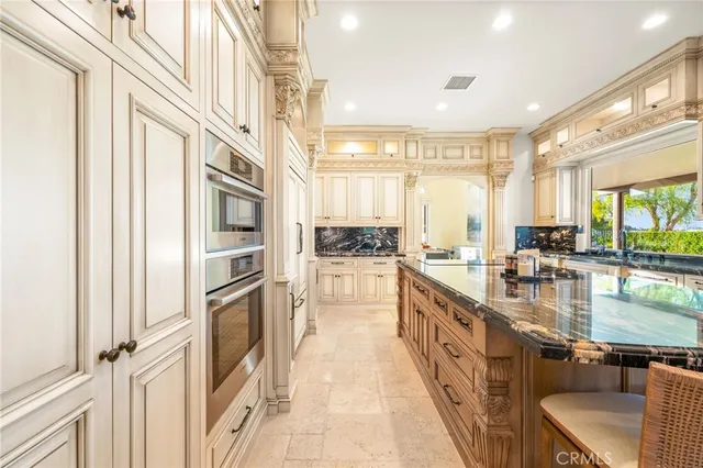 a kitchen with a sink and a stove next to a window
