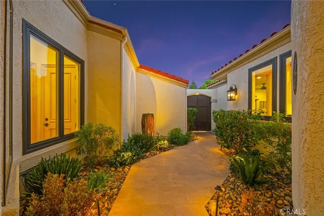 a front view of a house with a garden