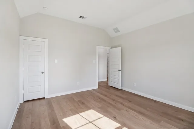 a view of an empty room and wooden floor