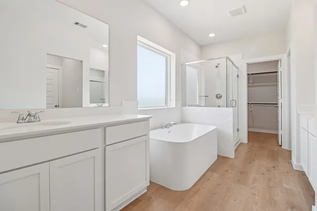 a spacious bathroom with a double vanity sink mirror and double