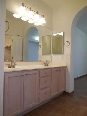a bathroom with a double vanity sink and a mirror