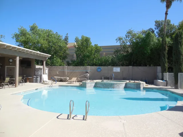 a view of swimming pool with seating space