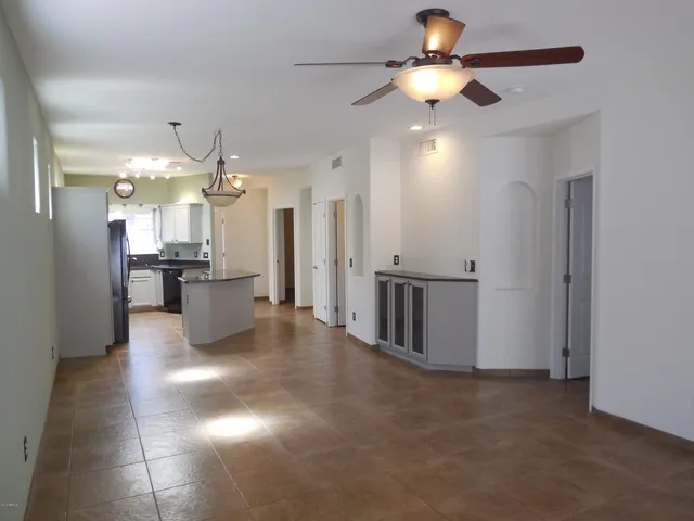 a view of a kitchen with a sink and a refrigerator