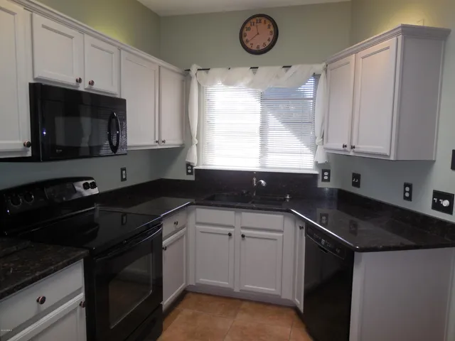 a kitchen with a sink stove and microwave