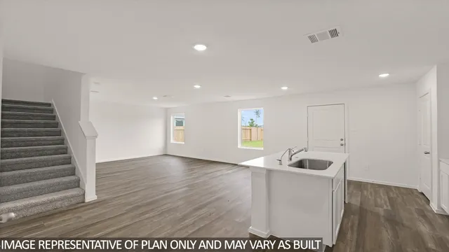 a view of kitchen with sink microwave and refrigerator