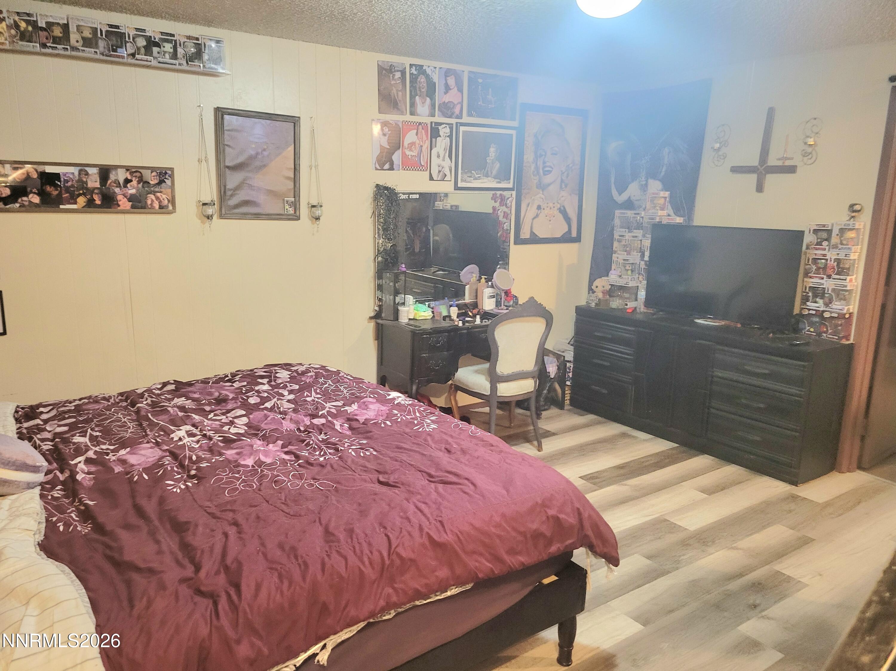 1404 East 9th Street, Unit 3 Reno, NV 89512 - Photo 17 of 29 a bedroom with a bed and wooden floor