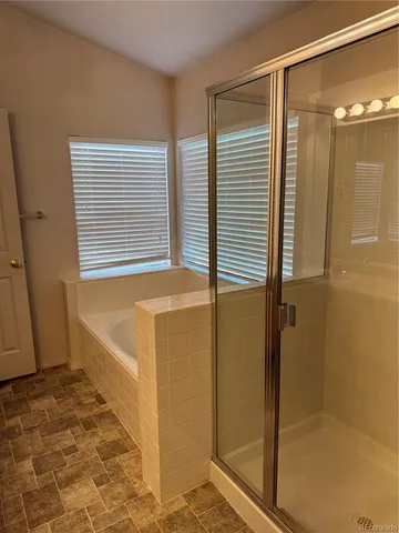 a bathroom with a tub and a shower