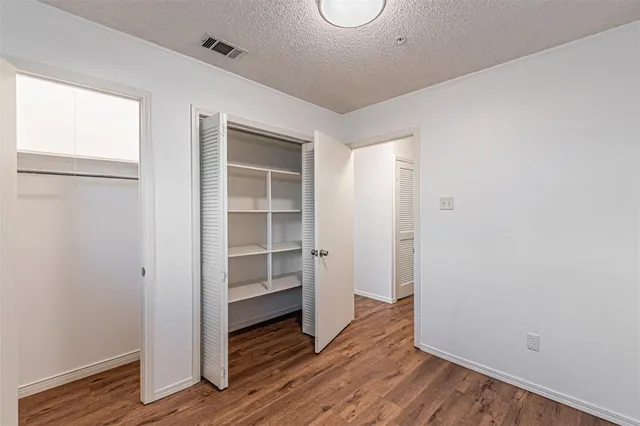 a view of wooden floor and windows in a room