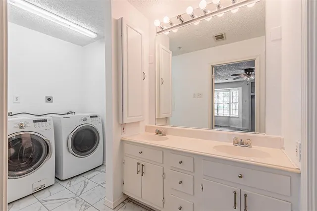 a spacious bathroom with a sink mirror and window