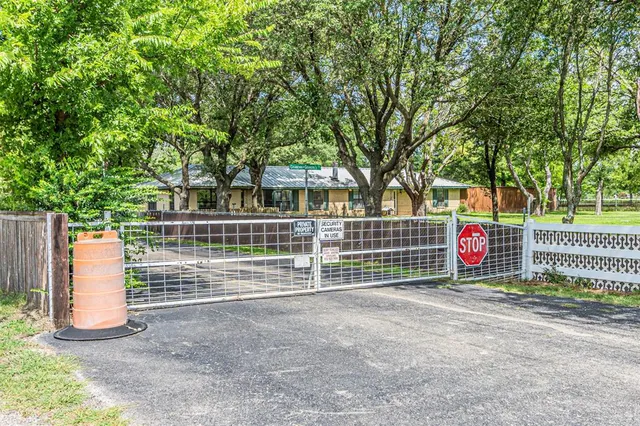 a view of a park with iron fence