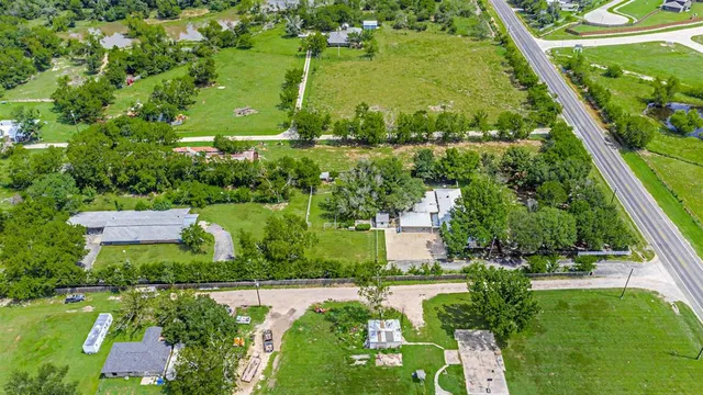 an aerial view of a residential houses with outdoor space and street view