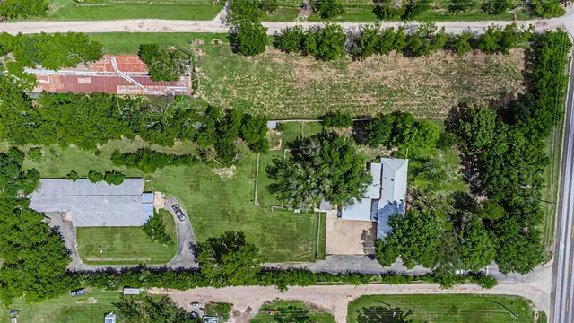 an aerial view of residential house with outdoor space and swimming pool