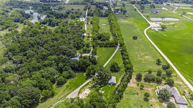 an aerial view of residential houses with outdoor space and swimming pool