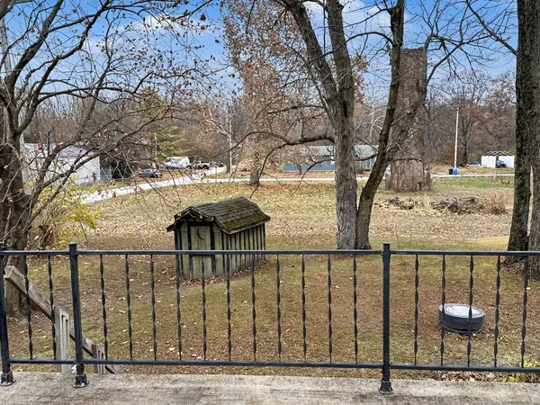 a view of a balcony with wooden fence