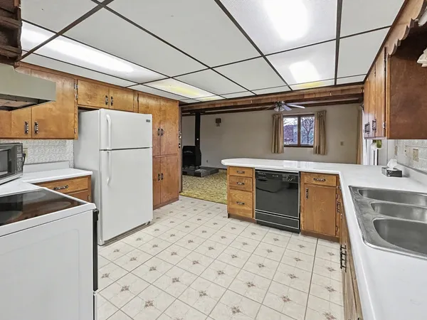 a kitchen with a refrigerator sink stove and cabinets