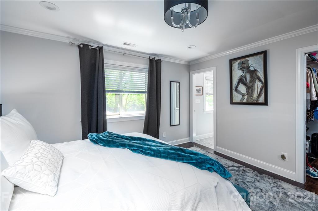 19007 Kailua Circle Tega Cay, SC 29708 - Photo 13 of 45 a bedroom with a large bed and a chandelier