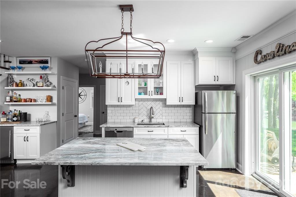 19007 Kailua Circle Tega Cay, SC 29708 - Photo 17 of 45 a kitchen with stainless steel appliances granite countertop a refrigerator a sink and a stove