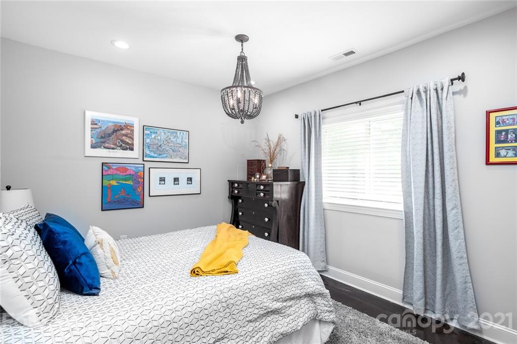 19007 Kailua Circle Tega Cay, SC 29708 - Photo 20 of 45 a bedroom with a bed and a chandelier