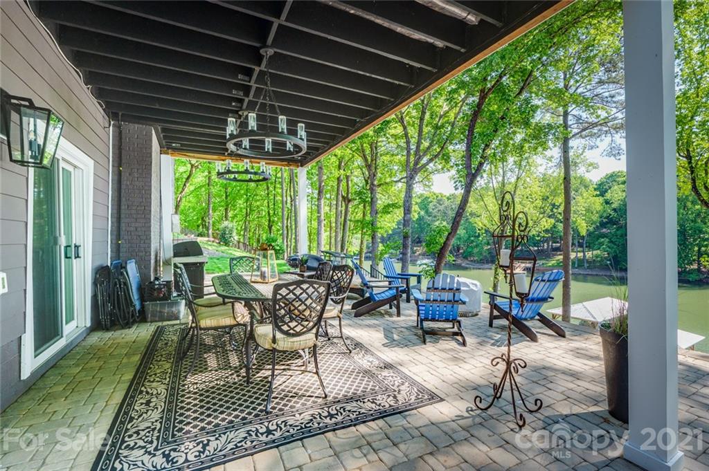 19007 Kailua Circle Tega Cay, SC 29708 - Photo 23 of 45 a view of a patio with chairs and floor to ceiling window