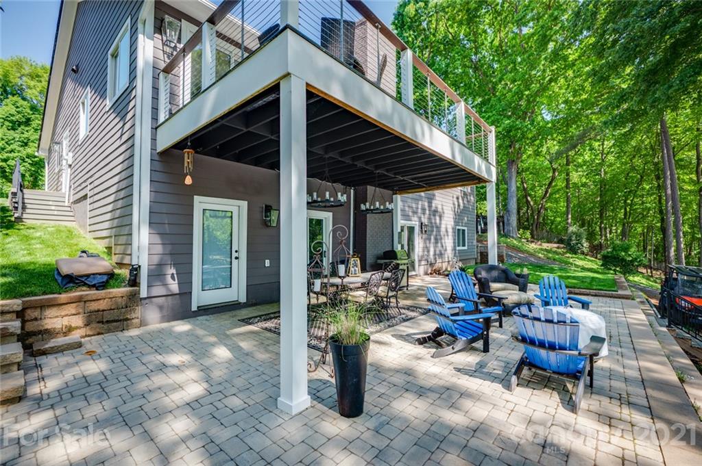 19007 Kailua Circle Tega Cay, SC 29708 - Photo 24 of 45 a view of a patio with table and chairs potted plants and large tree