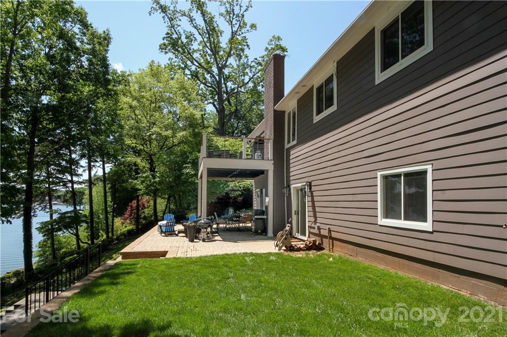 19007 Kailua Circle Tega Cay, SC 29708 - Photo 25 of 45 a view of a patio with table and chairs under an umbrella
