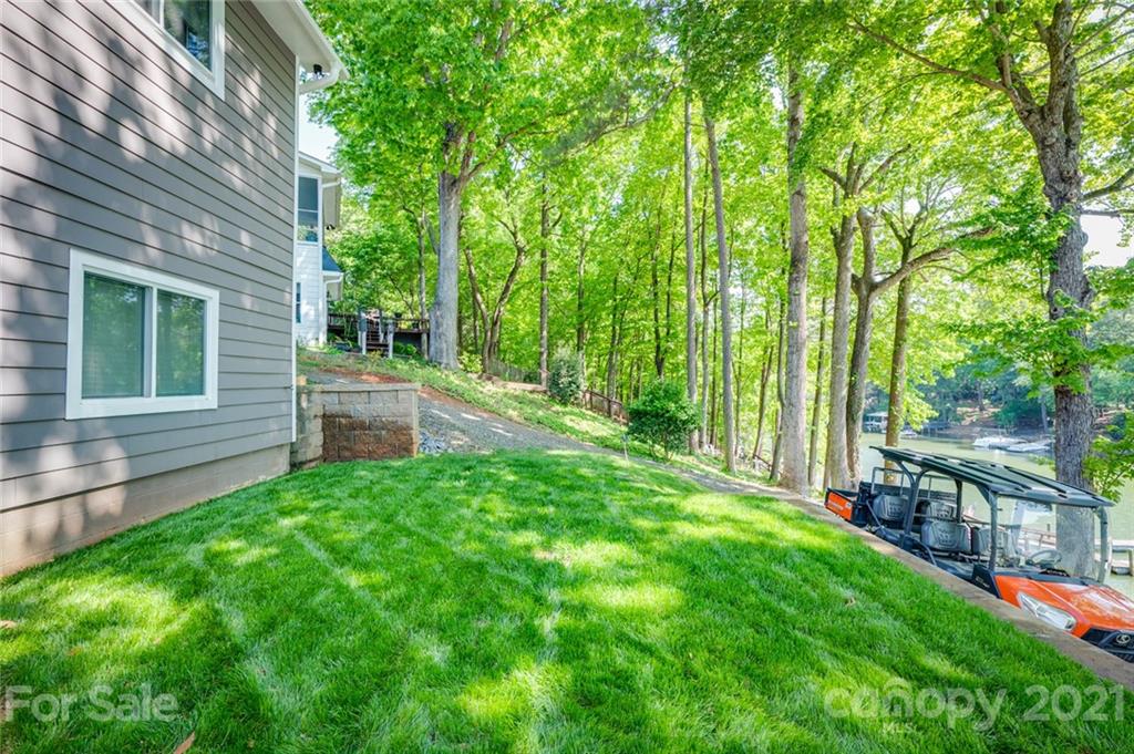 19007 Kailua Circle Tega Cay, SC 29708 - Photo 26 of 45 a view of a backyard with plants and large trees