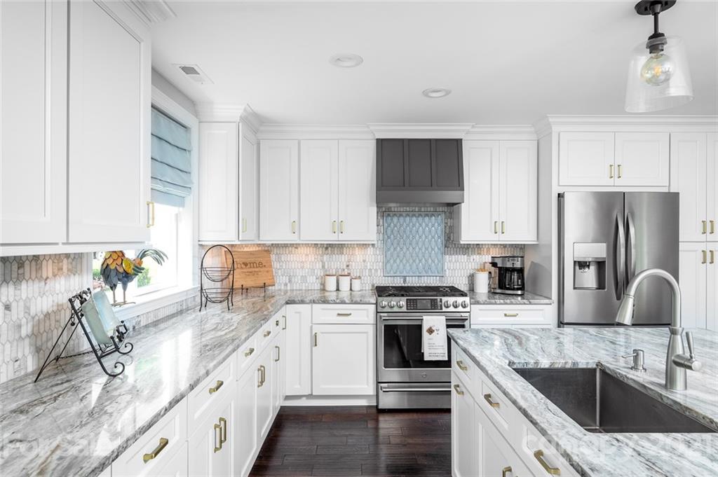 19007 Kailua Circle Tega Cay, SC 29708 - Photo 7 of 45 a kitchen with a sink stove and refrigerator