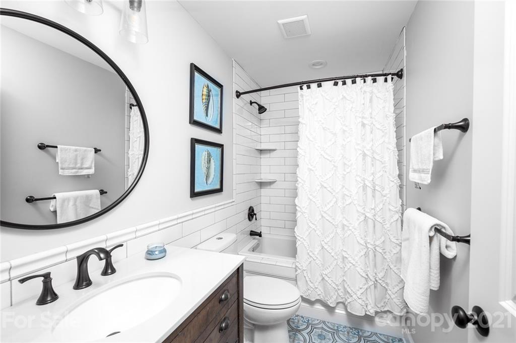 19007 Kailua Circle Tega Cay, SC 29708 - Photo 10 of 45 a bathroom with a sink a toilet and a mirror