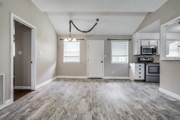 a view of a kitchen with microwave and cabinets