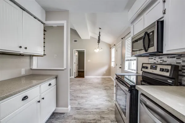 a kitchen with granite countertop a stove and a sink