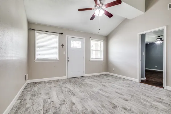 wooden floor in an empty room with a window
