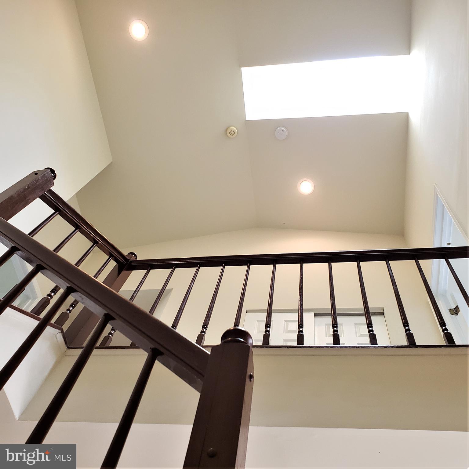 5263 Columbia Road, Unit 492 Columbia, MD 21044 - Photo 34 of 47 beautiful staircase with view of skylight