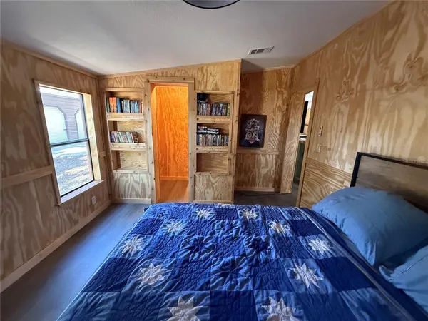 a bedroom with a large bed and a dresser