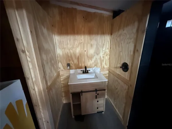 a bathroom with a shower and a sink